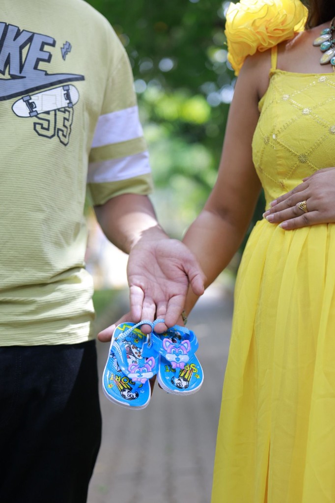 Maternity session — couple with baby shoes, Usha Photo Studio