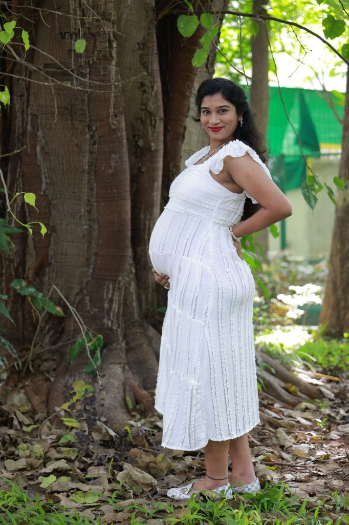 Maternity portrait in white dress by a tree, Usha Photo Studio