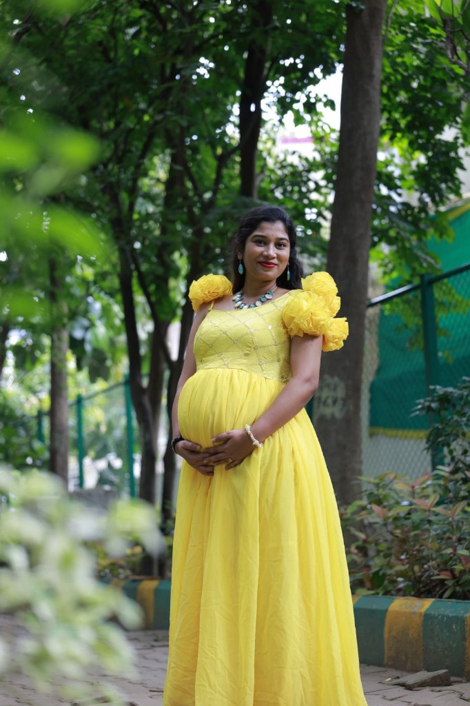 Professional maternity portrait in a flowing yellow gown, Usha Photo Studio